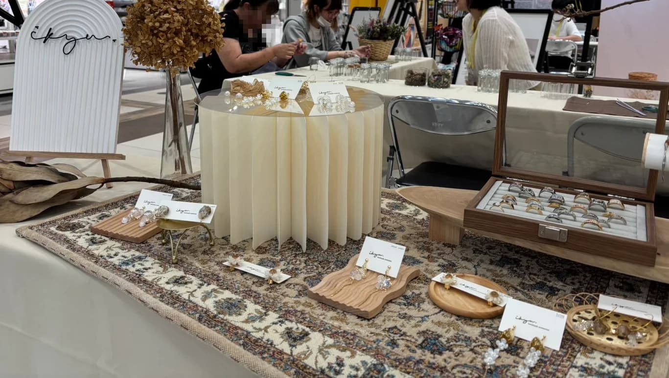 ワークショップに併設したikyuアクセサリーの展示。絨毯の上に、ピアスやリングとドライフラワーが並ぶ